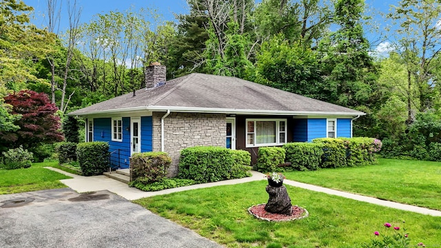 5 Reservoir Rd, Norwich, CT 06360 - view of front of property with a chimney, a front lawn, stone siding, and a shingled roof