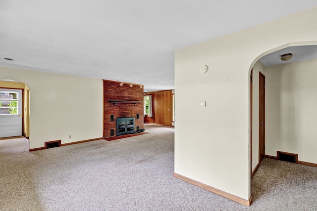 5 Reservoir Rd, Norwich, CT 06360 - unfurnished living room featuring carpet, arched walkways, and baseboards