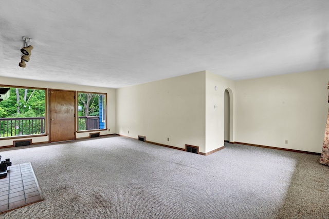 5 Reservoir Rd, Norwich, CT 06360 - unfurnished living room featuring carpet floors, arched walkways, and baseboards