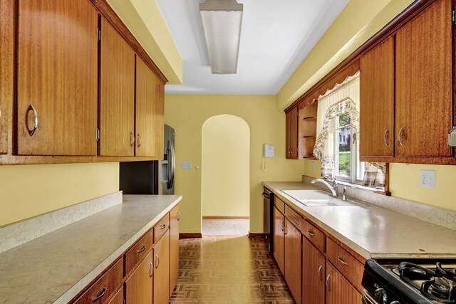 5 Reservoir Rd, Norwich, CT 06360 - kitchen featuring a sink, light countertops, dishwashing machine, arched walkways, and range with gas cooktop