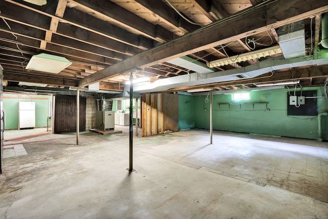 5 Reservoir Rd, Norwich, CT 06360 - basement with freestanding refrigerator and heating unit