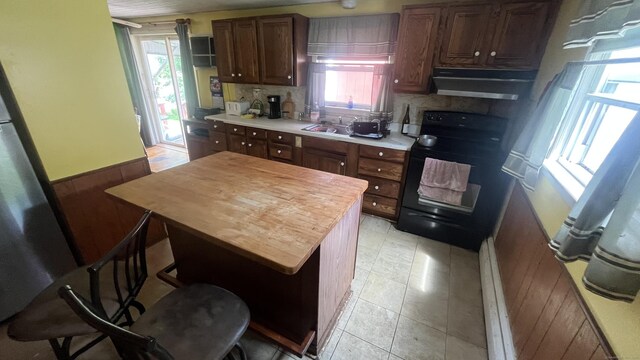 40 Batt St, Middletown, CT 06457 - kitchen with under cabinet range hood, electric range, light countertops, and plenty of natural light