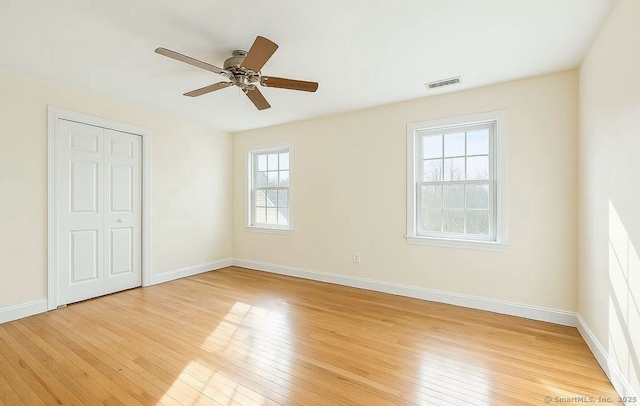 10 Secor Rd, Brookfield, CT 06804 - unfurnished bedroom featuring light wood-style floors, baseboards, ceiling fan, and a closet