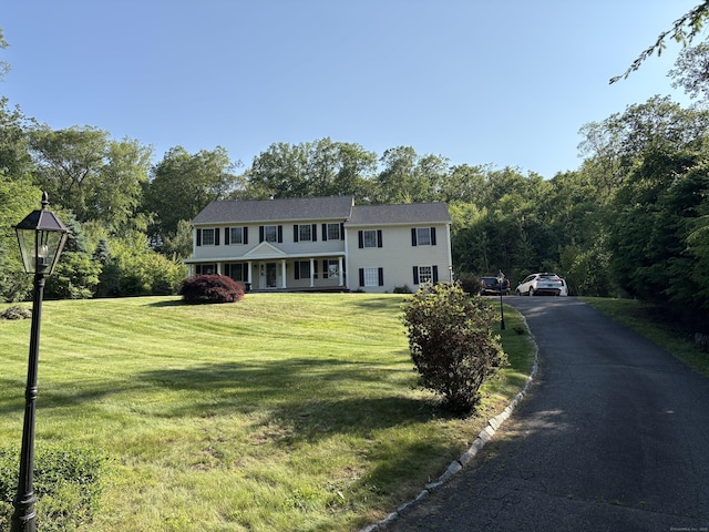10 Secor Rd, Brookfield, CT 06804 - view of front of property with a front lawn, covered porch, and a view of trees