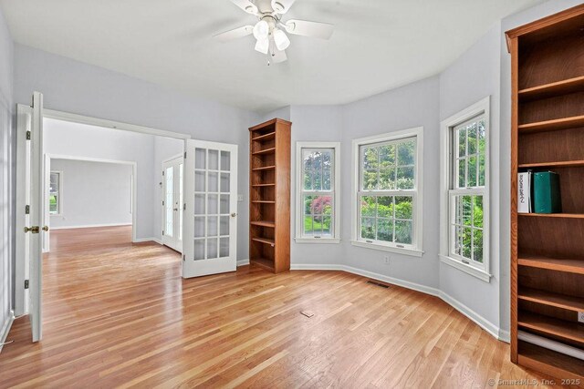 657 Tamarack Rd, Cheshire, CT 06410 - empty room with french doors, light wood-type flooring, a ceiling fan, and baseboards