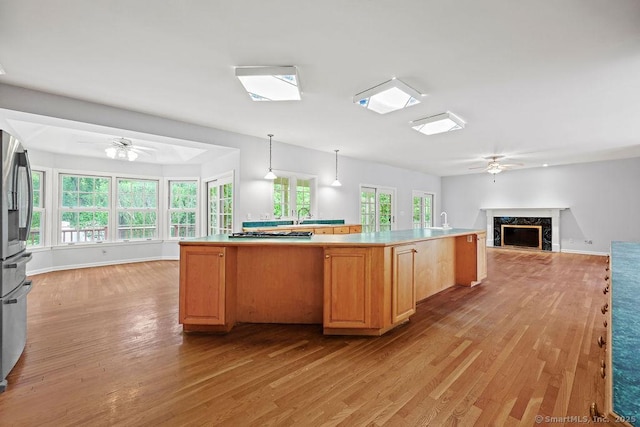 657 Tamarack Rd, Cheshire, CT 06410 - kitchen with ceiling fan, open floor plan, light wood-style floors, and a high end fireplace