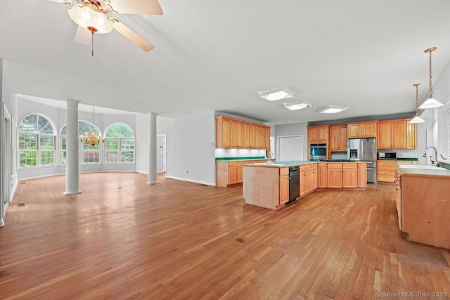 657 Tamarack Rd, Cheshire, CT 06410 - kitchen featuring stainless steel appliances, decorative columns, light wood-type flooring, open floor plan, and a kitchen island