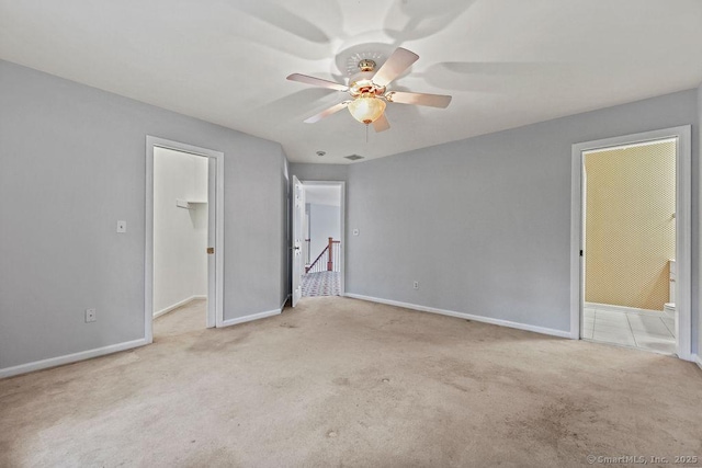 657 Tamarack Rd, Cheshire, CT 06410 - unfurnished bedroom with carpet, a spacious closet, baseboards, and a ceiling fan
