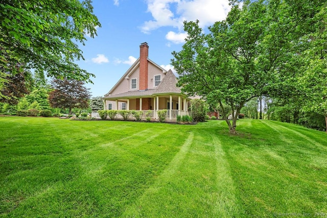 657 Tamarack Rd, Cheshire, CT 06410 - rear view of house featuring covered porch, a chimney, and a lawn
