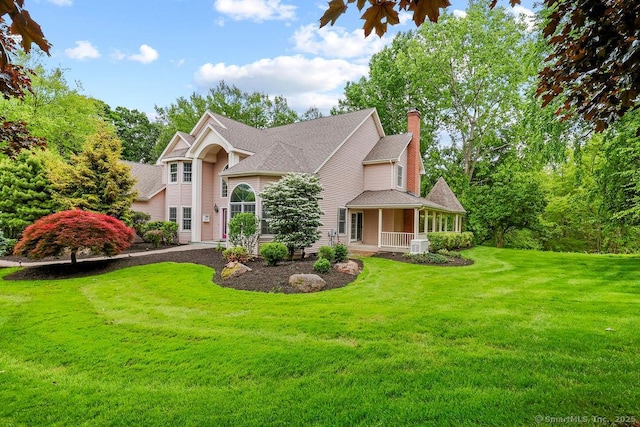 657 Tamarack Rd, Cheshire, CT 06410 - view of front facade with a front lawn, a chimney, covered porch, and roof with shingles