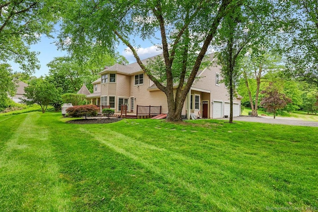 657 Tamarack Rd, Cheshire, CT 06410 - view of green lawn with a deck and asphalt driveway