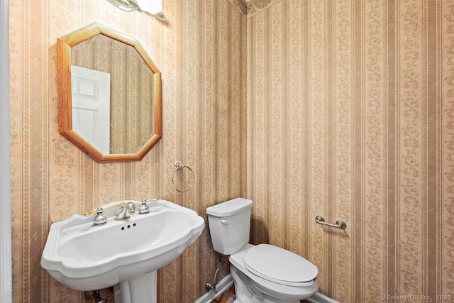 657 Tamarack Rd, Cheshire, CT 06410 - half bathroom featuring a sink, toilet, and wallpapered walls