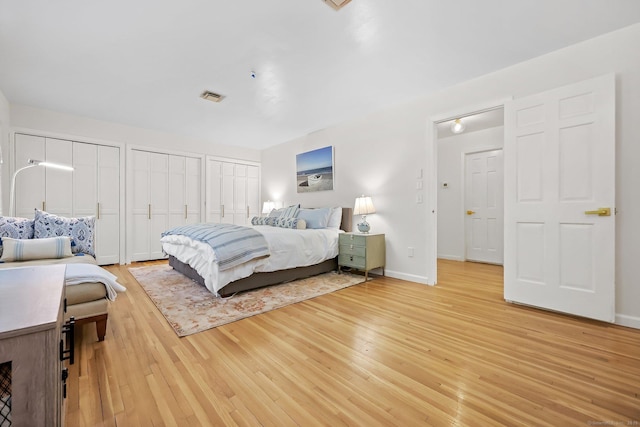 30 Norfield Woods Rd, Weston, CT 06883 - bedroom with light wood-style floors, two closets, and baseboards