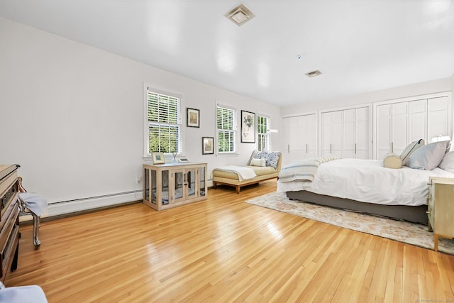 30 Norfield Woods Rd, Weston, CT 06883 - bedroom featuring hardwood / wood-style flooring, two closets, and baseboard heating