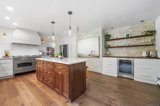 30 Norfield Woods Rd, Weston, CT 06883 - kitchen with appliances with stainless steel finishes, beverage cooler, custom range hood, brick wall, and white cabinets