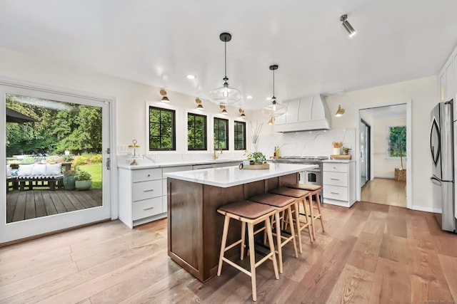 30 Norfield Woods Rd, Weston, CT 06883 - kitchen featuring custom range hood, appliances with stainless steel finishes, white cabinetry, plenty of natural light, and recessed lighting