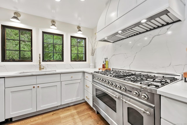 30 Norfield Woods Rd, Weston, CT 06883 - kitchen with custom exhaust hood, double oven range, a sink, and healthy amount of natural light