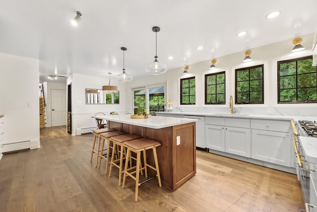 30 Norfield Woods Rd, Weston, CT 06883 - kitchen with a sink, a baseboard heating unit, dishwashing machine, a center island, and a baseboard radiator