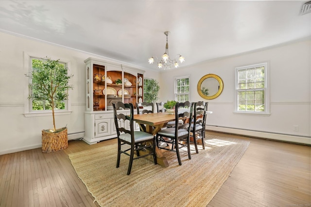 30 Norfield Woods Rd, Weston, CT 06883 - dining area with a baseboard radiator, crown molding, a chandelier, and light wood finished floors