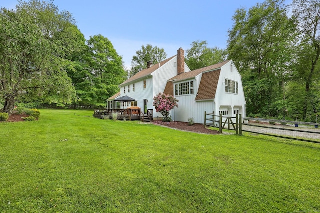 30 Norfield Woods Rd, Weston, CT 06883 - rear view of house with a gambrel roof, a wooden deck, an attached garage, roof with shingles, and a chimney