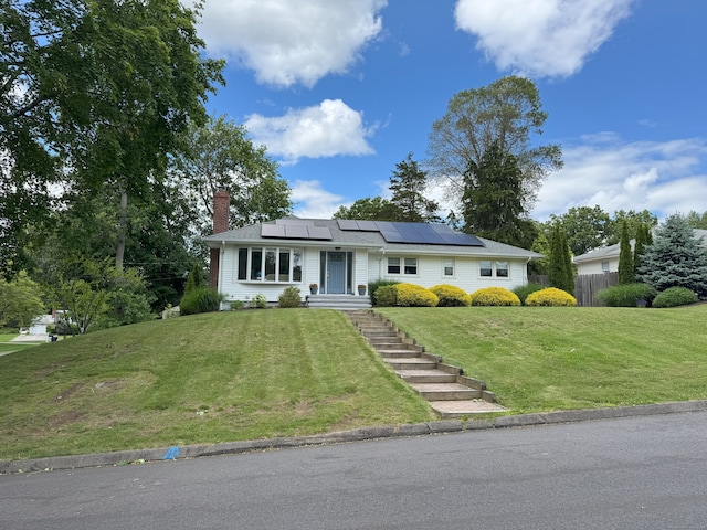 38 Kingston Rd, Trumbull, CT 06611 - ranch-style home with roof mounted solar panels and a chimney