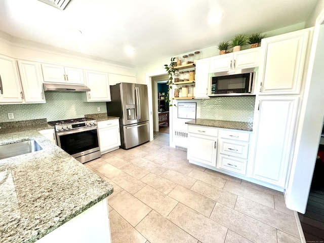 38 Kingston Rd, Trumbull, CT 06611 - kitchen featuring appliances with stainless steel finishes, under cabinet range hood, light stone counters, open shelves, and white cabinetry