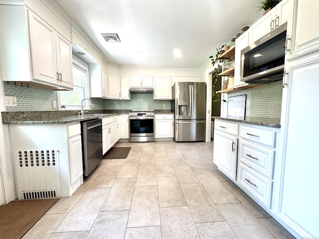 38 Kingston Rd, Trumbull, CT 06611 - kitchen featuring stainless steel appliances, radiator heating unit, under cabinet range hood, and white cabinets