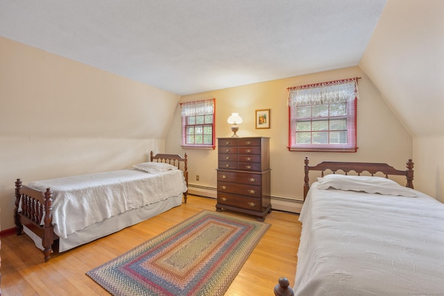 12 Whispering Rod Rd, Farmington, CT 06085 - bedroom with lofted ceiling, wood finished floors, and a baseboard heating unit
