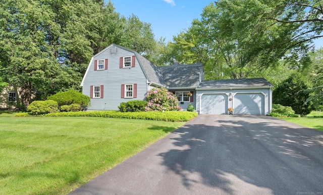 12 Whispering Rod Rd, Farmington, CT 06085 - dutch colonial featuring driveway, an attached garage, a front yard, and a gambrel roof
