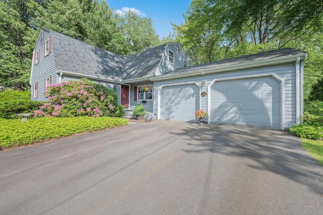 12 Whispering Rod Rd, Farmington, CT 06085 - dutch colonial featuring a gambrel roof, asphalt driveway, a garage, and a shingled roof
