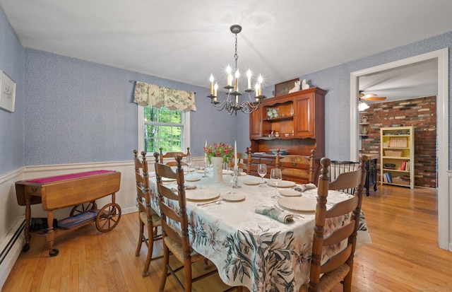 12 Whispering Rod Rd, Farmington, CT 06085 - dining area with a baseboard heating unit, light wood-type flooring, a chandelier, and a wainscoted wall