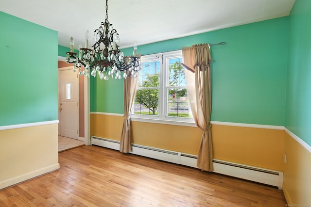 670 Avery St, South Windsor, CT 06074 - unfurnished dining area with a chandelier, a baseboard heating unit, wood finished floors, and baseboards