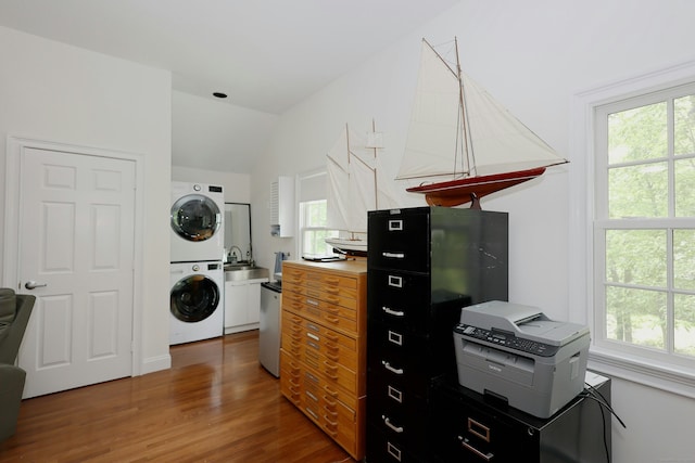 114 Peaceable Ridge Rd, Ridgefield, CT 06877 - kitchen featuring stacked washer / drying machine, vaulted ceiling, healthy amount of natural light, a sink, and wood finished floors