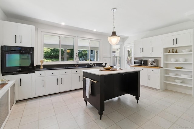 8 Washington Ave, Westport, CT 06880 - kitchen featuring oven, stainless steel microwave, open shelves, hanging light fixtures, and light tile patterned flooring