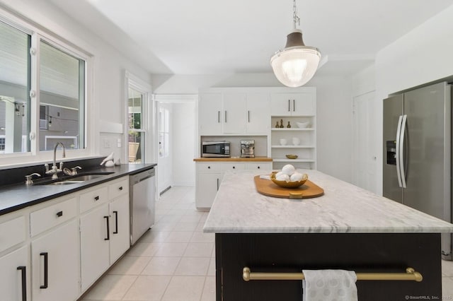 8 Washington Ave, Westport, CT 06880 - kitchen with appliances with stainless steel finishes, open shelves, a sink, and white cabinetry