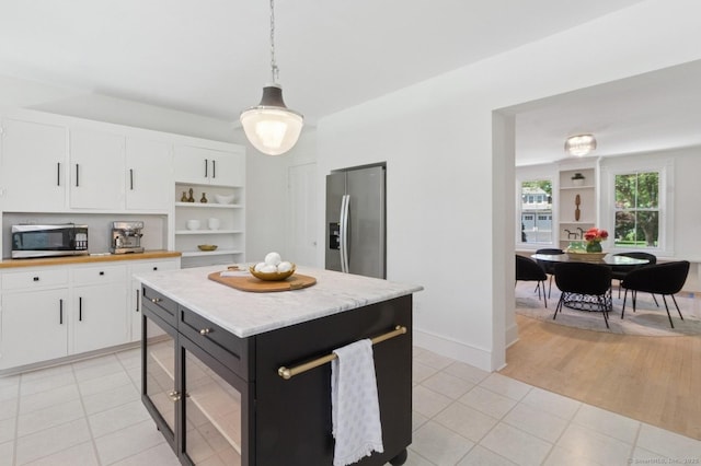 8 Washington Ave, Westport, CT 06880 - kitchen with stainless steel appliances, pendant lighting, white cabinetry, light tile patterned flooring, and open shelves