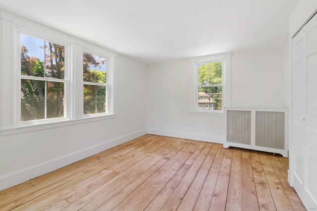 8 Washington Ave, Westport, CT 06880 - spare room featuring radiator, light wood-style floors, and baseboards