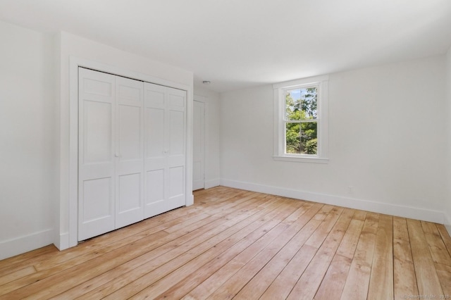 8 Washington Ave, Westport, CT 06880 - unfurnished bedroom featuring hardwood / wood-style floors, baseboards, and a closet