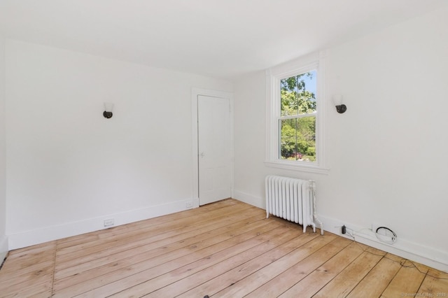 8 Washington Ave, Westport, CT 06880 - empty room with radiator heating unit, wood-type flooring, and baseboards