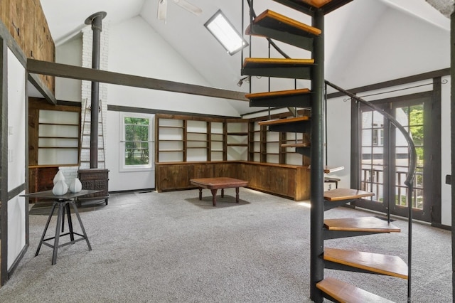 8 Washington Ave, Westport, CT 06880 - living room featuring carpet, a wood stove, healthy amount of natural light, and high vaulted ceiling