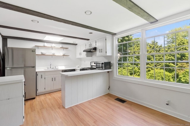 8 Washington Ave, Westport, CT 06880 - kitchen with beam ceiling, appliances with stainless steel finishes, light countertops, a sink, and healthy amount of natural light