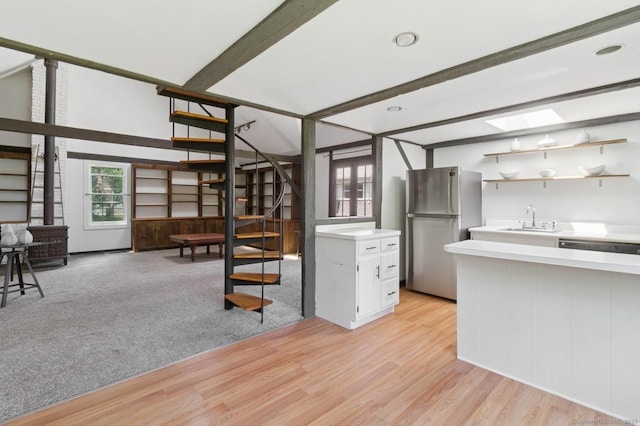 8 Washington Ave, Westport, CT 06880 - kitchen featuring freestanding refrigerator, a sink, light countertops, light wood-type flooring, and beam ceiling