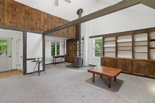 8 Washington Ave, Westport, CT 06880 - sitting room featuring high vaulted ceiling, carpet, a wood stove, plenty of natural light, and a ceiling fan