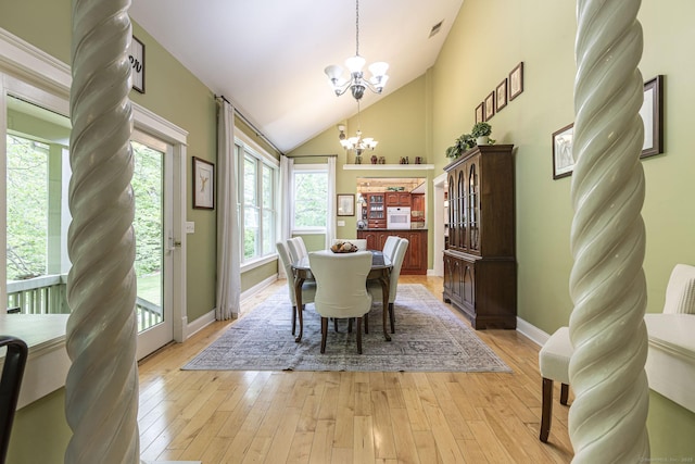 61 Baldwin Brook Rd, Canterbury, CT 06331 - dining area with a chandelier, light wood-type flooring, vaulted ceiling, and baseboards