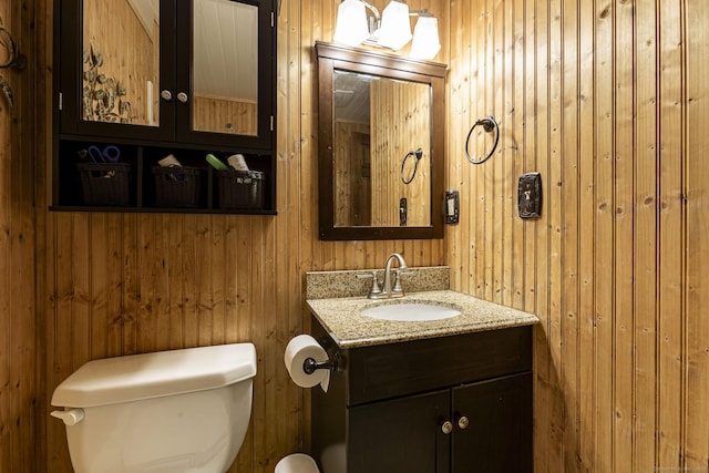 61 Baldwin Brook Rd, Canterbury, CT 06331 - bathroom featuring toilet, wood walls, and vanity