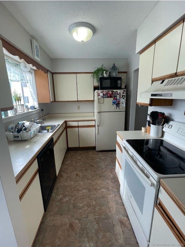 9 Staffordshire Commons Dr Unit 9, Wallingford, CT 06492 - kitchen with black appliances, under cabinet range hood, light countertops, stone finish floors, and a textured ceiling