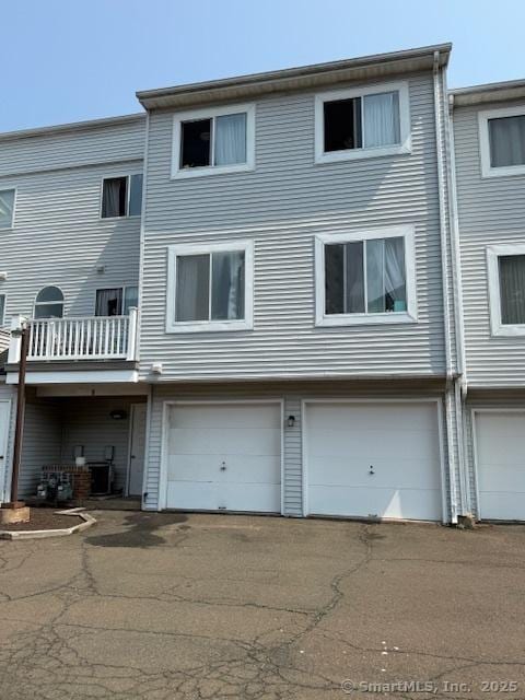 9 Staffordshire Commons Dr Unit 9, Wallingford, CT 06492 - rear view of house with an attached garage and driveway