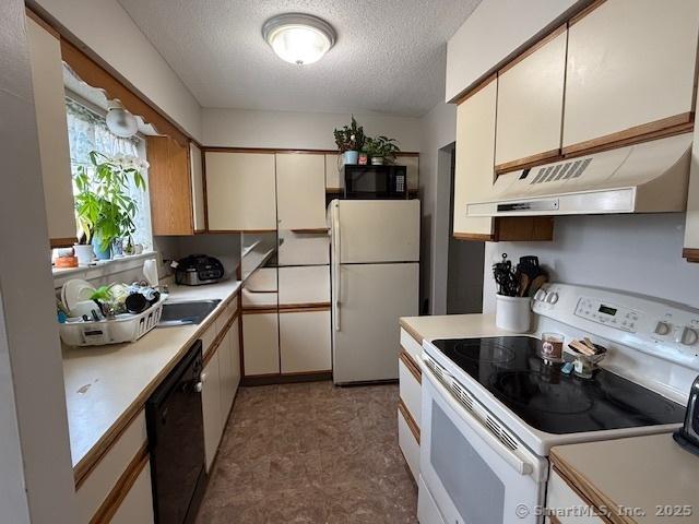 9 Staffordshire Commons Dr Unit 9, Wallingford, CT 06492 - kitchen with black appliances, custom range hood, a textured ceiling, light countertops, and white cabinets