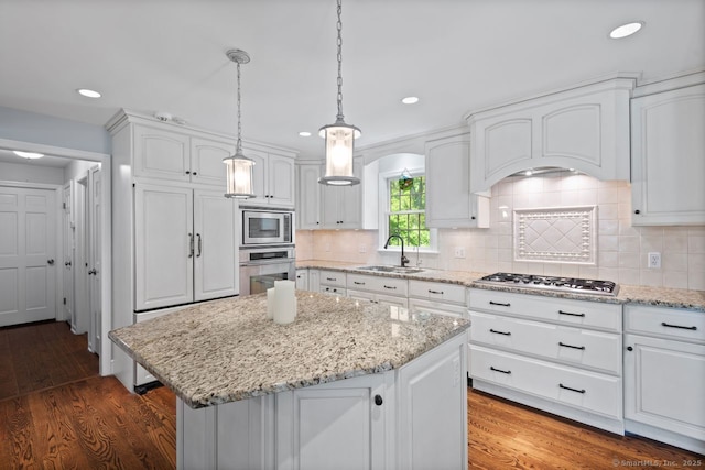 3 Colonial Dr, Clinton, CT 06413 - kitchen featuring appliances with stainless steel finishes, a kitchen island, white cabinets, wood finished floors, and recessed lighting