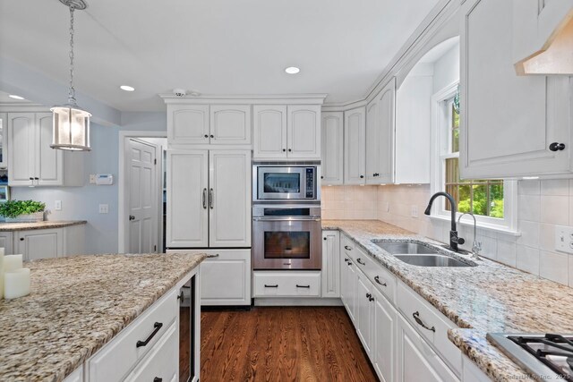 3 Colonial Dr, Clinton, CT 06413 - kitchen featuring built in appliances, white cabinets, beverage cooler, recessed lighting, and hanging light fixtures